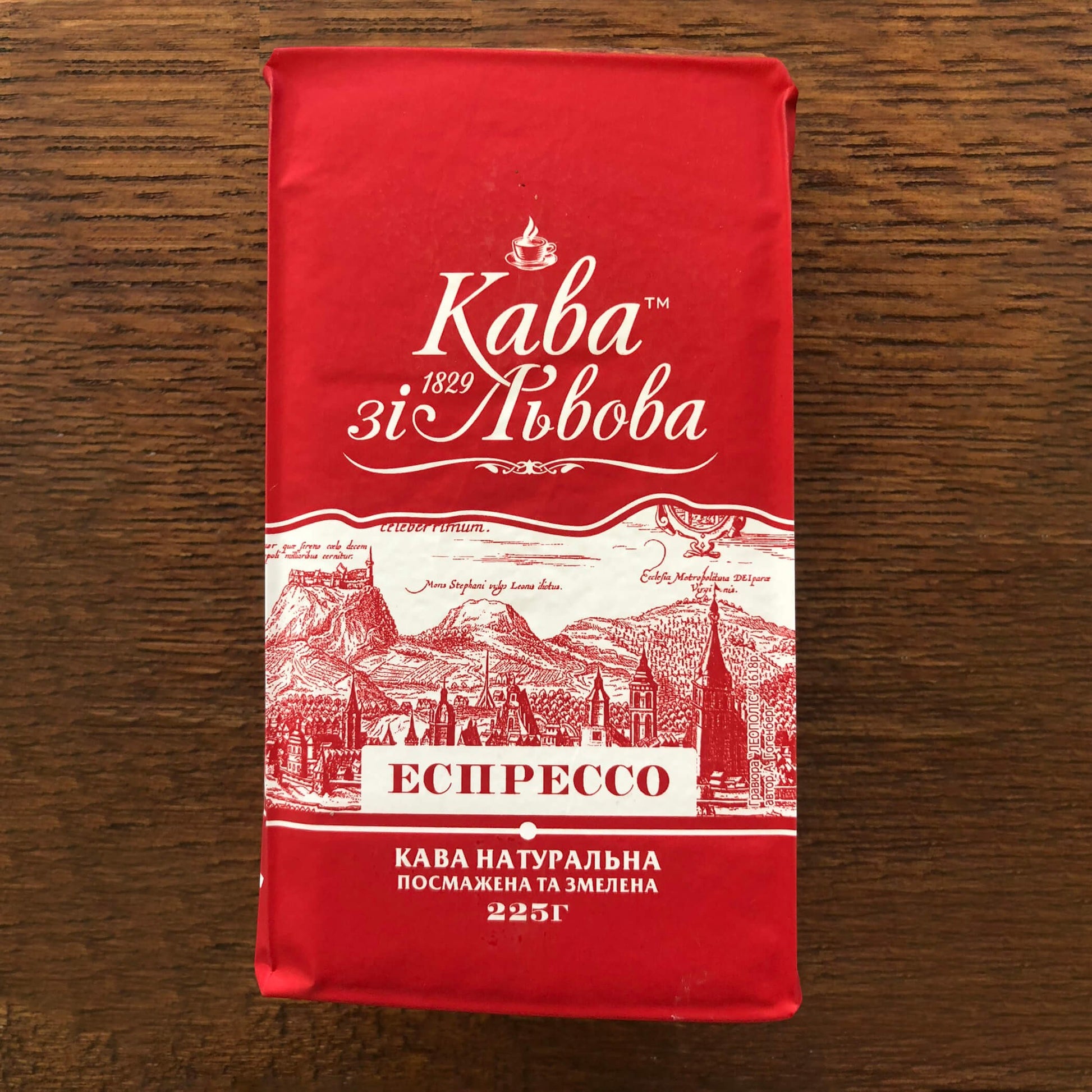 The March Initiative ESPRESSO 225g coffee bag, red with white text and illustrations of a city skyline and mountains.