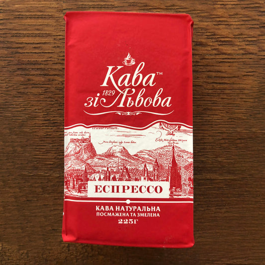 The March Initiative ESPRESSO 225g coffee bag, red with white text and illustrations of a city skyline and mountains.